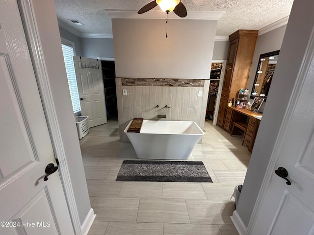 bathroom featuring tile walls, a bath, tile patterned floors, ornamental molding, and ceiling fan