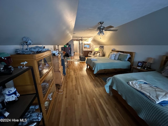 bedroom with lofted ceiling, wood-type flooring, and ceiling fan