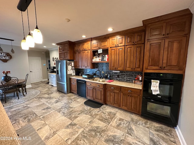 kitchen featuring sink, black appliances, light stone counters, backsplash, and decorative light fixtures