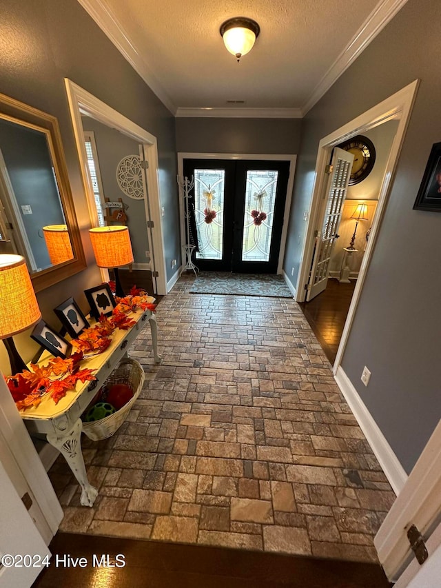 entryway with french doors, dark wood-type flooring, a textured ceiling, and crown molding