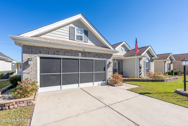 view of front of house with a front yard and a garage