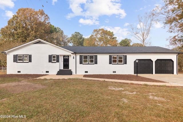 ranch-style house with a front yard and a garage