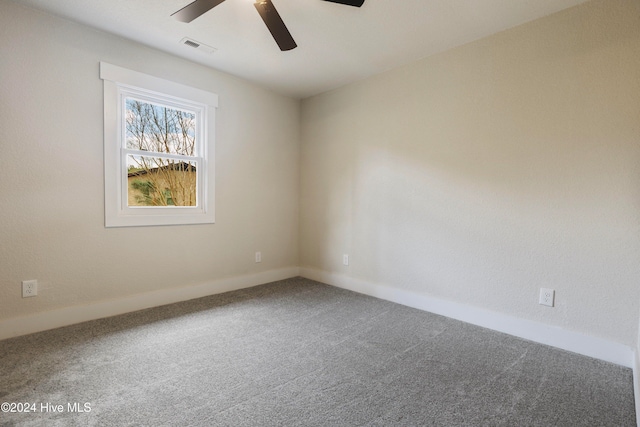 carpeted spare room featuring ceiling fan