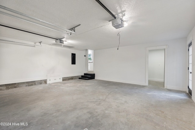 garage with electric panel and a garage door opener