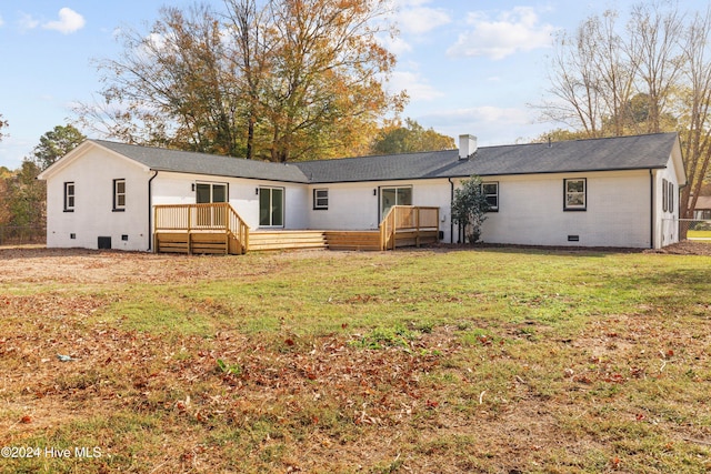 rear view of house with a lawn and a deck