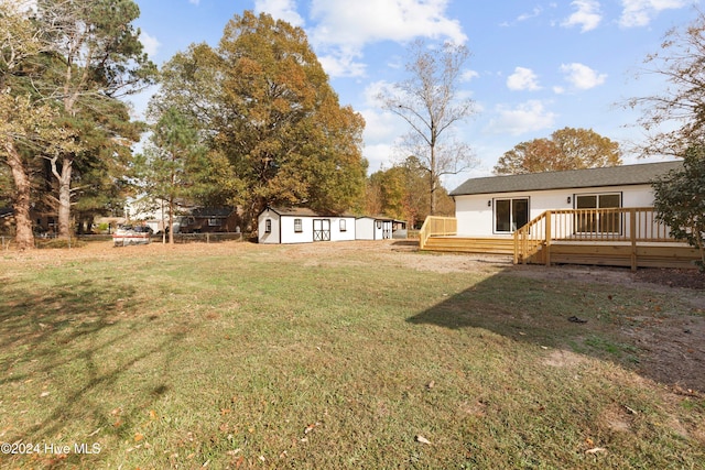 view of yard with an outbuilding and a wooden deck