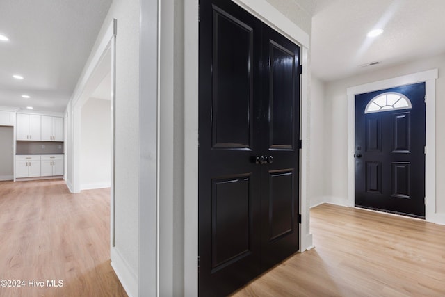 foyer with light hardwood / wood-style floors