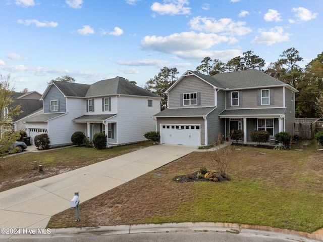 front of property with a front lawn, a garage, and a porch