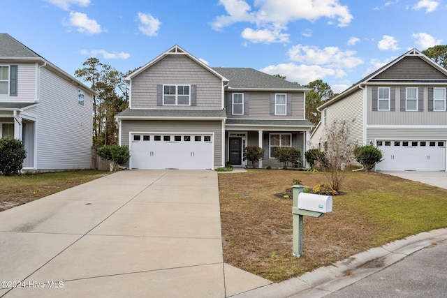 view of front property with covered porch, a garage, and a front yard