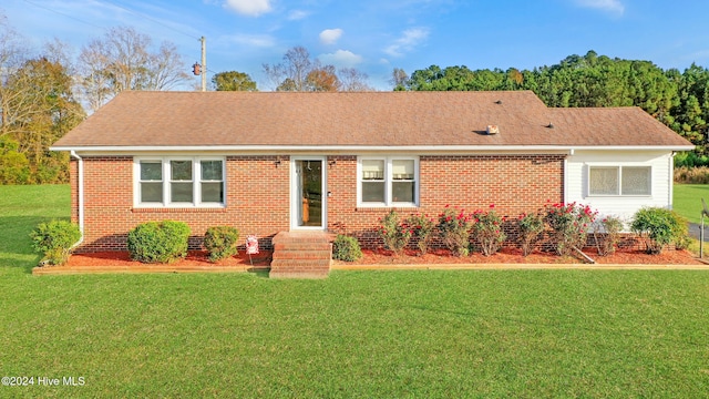 ranch-style home with a front lawn