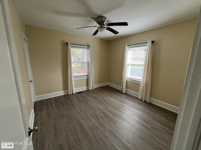 unfurnished bedroom featuring dark wood-type flooring and ceiling fan