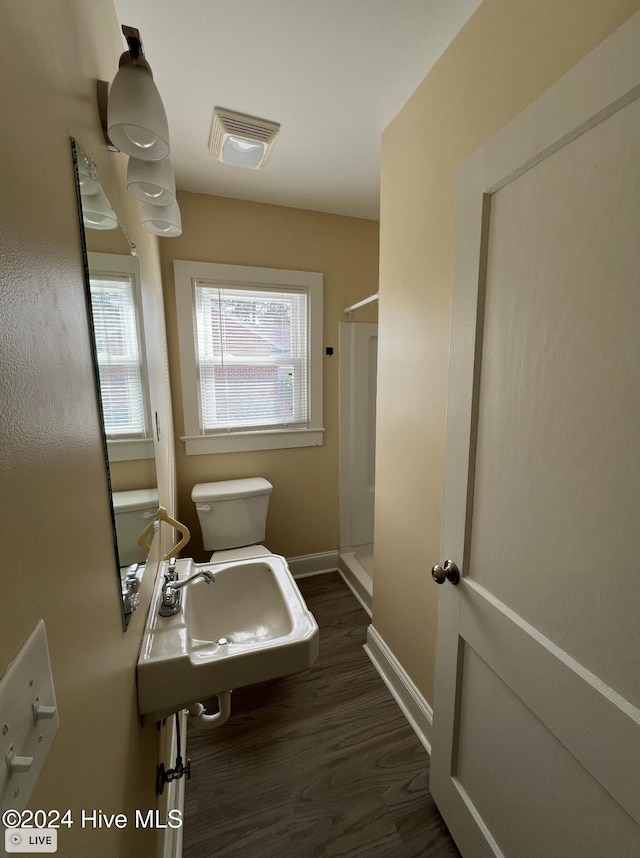 bathroom featuring walk in shower, sink, toilet, and hardwood / wood-style floors