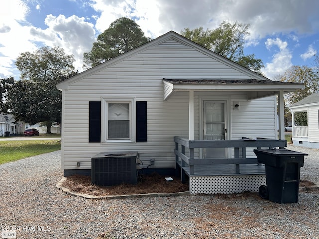 view of front of property featuring a wooden deck and central AC