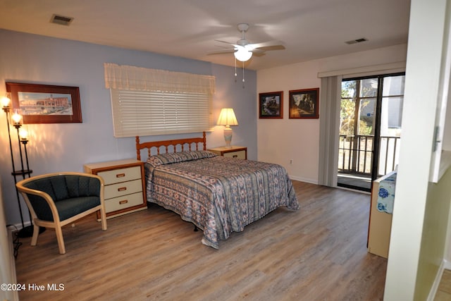 bedroom with hardwood / wood-style floors, ceiling fan, and access to exterior
