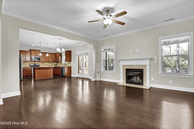 dining area featuring dark hardwood / wood-style floors, ornamental molding, ceiling fan with notable chandelier, and decorative columns