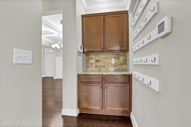 living room with crown molding, a healthy amount of sunlight, and dark hardwood / wood-style floors