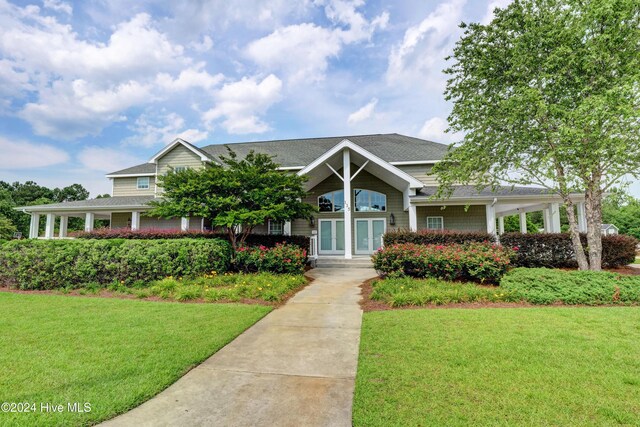 farmhouse-style home with a front yard and a porch