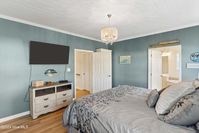 bedroom featuring ensuite bathroom, light hardwood / wood-style floors, and crown molding