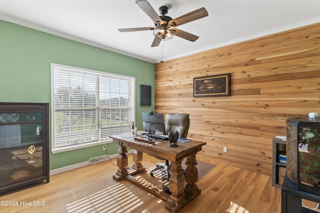 office with wood walls, ceiling fan, light hardwood / wood-style flooring, and ornamental molding