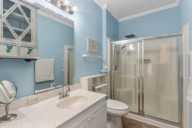 bathroom featuring a shower with door, crown molding, vanity, tile patterned flooring, and toilet