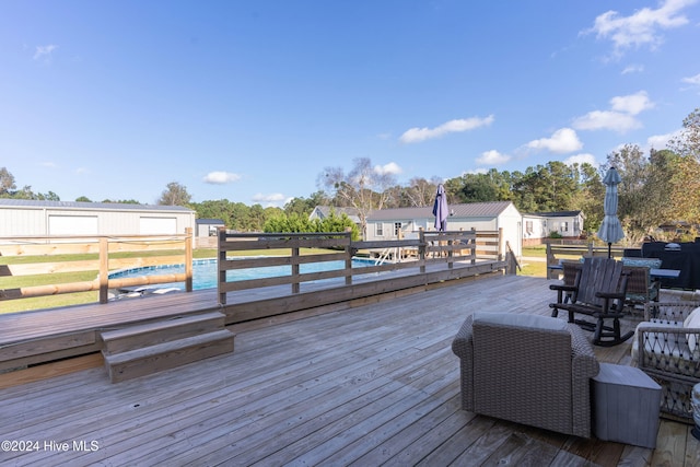 wooden deck with a swimming pool