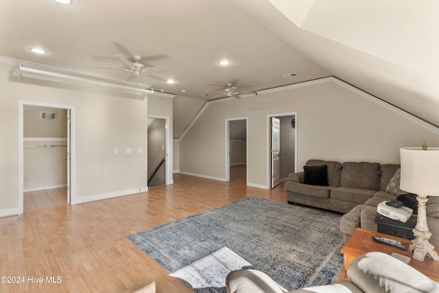 living room featuring ceiling fan, light hardwood / wood-style flooring, vaulted ceiling, and ornamental molding