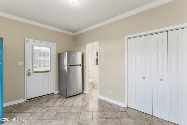 kitchen featuring stainless steel fridge and crown molding