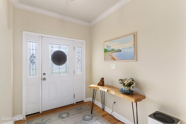 entrance foyer featuring wood-type flooring and crown molding