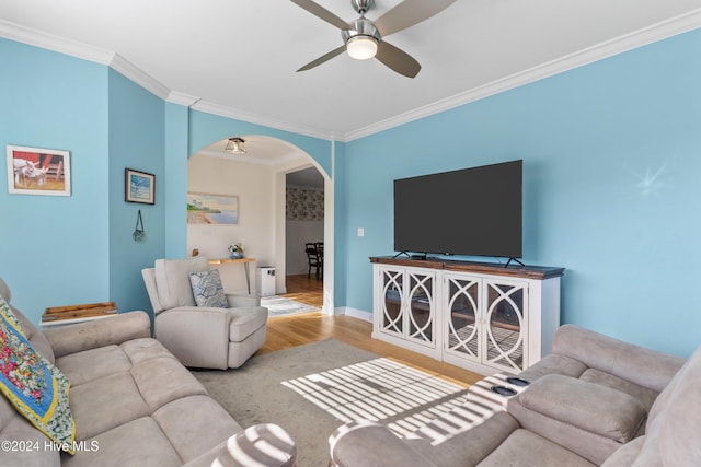 living room with ornamental molding, light hardwood / wood-style flooring, and ceiling fan