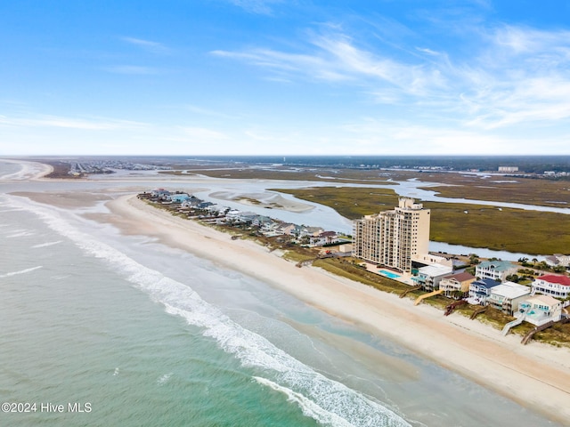 birds eye view of property with a water view and a view of the beach