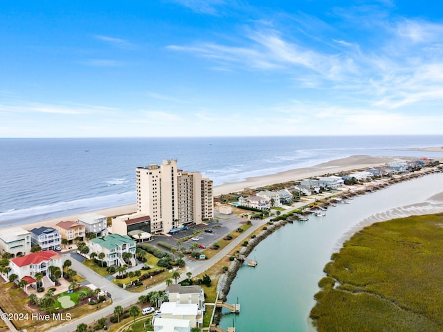 birds eye view of property featuring a water view and a beach view