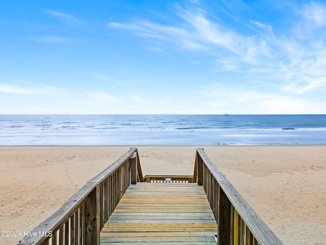 surrounding community featuring a water view and a view of the beach