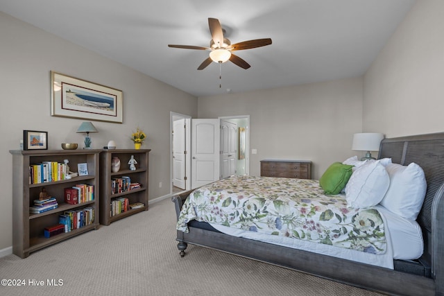 bedroom with ceiling fan and light carpet