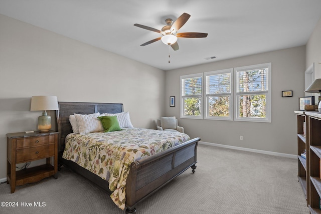 bedroom with ceiling fan and light colored carpet