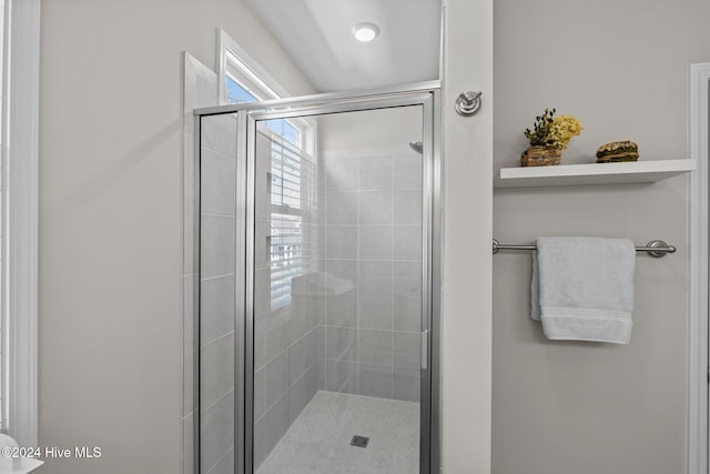 bathroom with a shower with door