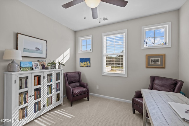 sitting room featuring ceiling fan and light colored carpet