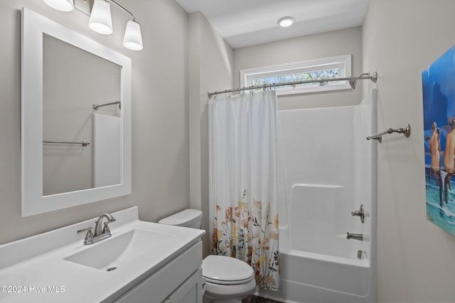 full bathroom with shower / tub combo with curtain, vanity, and toilet