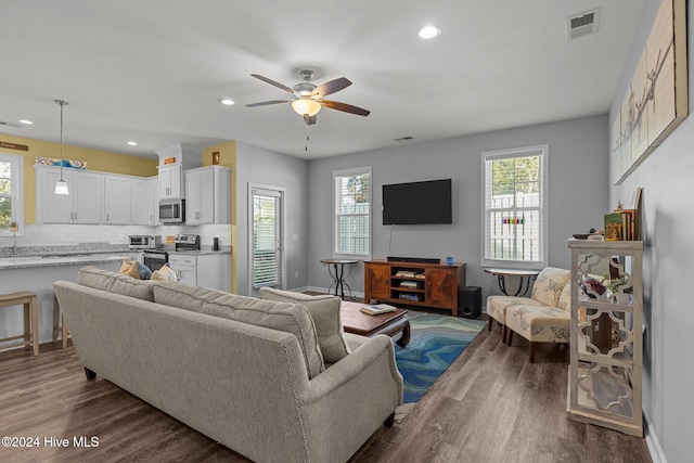 living room with ceiling fan and hardwood / wood-style floors