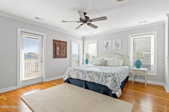 bedroom with multiple windows, visible vents, and ornamental molding