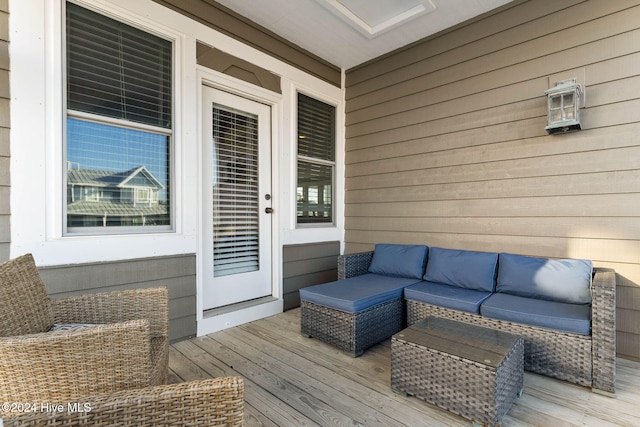 wooden terrace featuring an outdoor living space