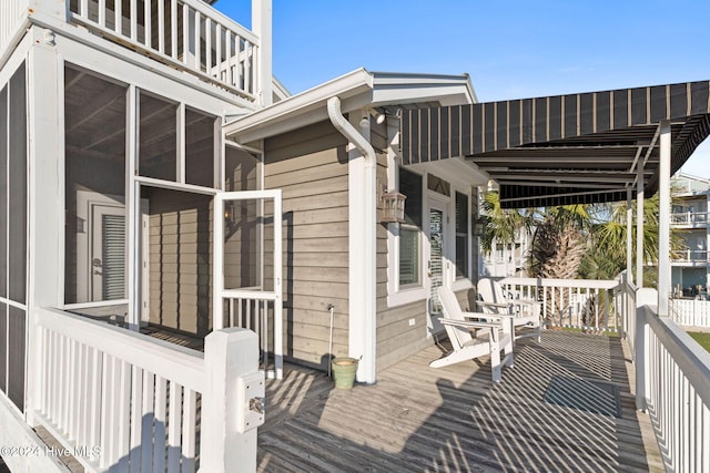 wooden deck with a sunroom