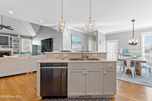 kitchen featuring stainless steel dishwasher, white cabinetry, sink, and pendant lighting