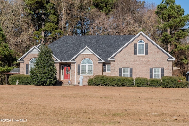 view of property featuring a front lawn