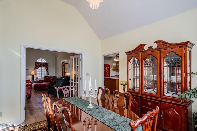 dining room featuring hardwood / wood-style flooring and high vaulted ceiling