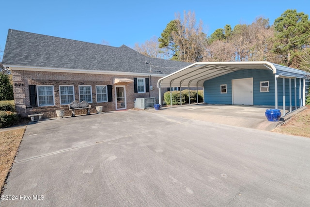 ranch-style home featuring a carport and central air condition unit