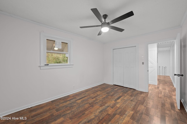 unfurnished bedroom featuring ornamental molding, a closet, ceiling fan, and dark wood-type flooring