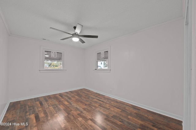 empty room with a textured ceiling, dark hardwood / wood-style floors, ceiling fan, and ornamental molding