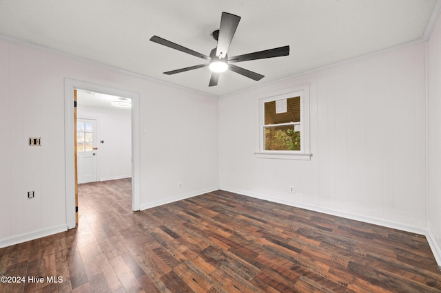 spare room featuring a wealth of natural light, ceiling fan, dark hardwood / wood-style floors, and ornamental molding