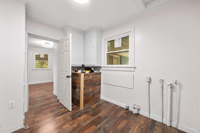 corridor with dark hardwood / wood-style flooring