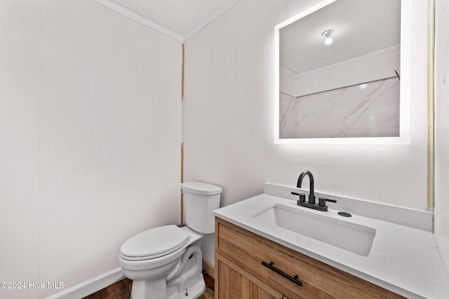 bathroom featuring vanity, toilet, ornamental molding, and wood-type flooring